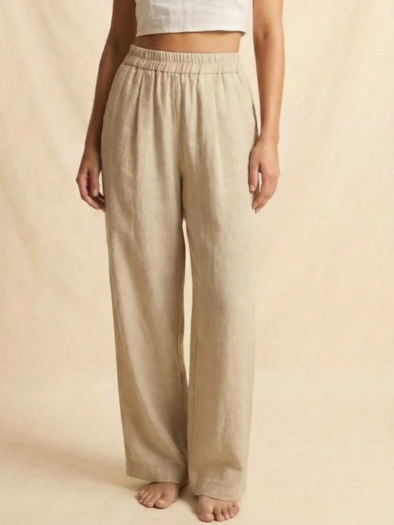 Beige pants with a fluid, minimalist silhouette.