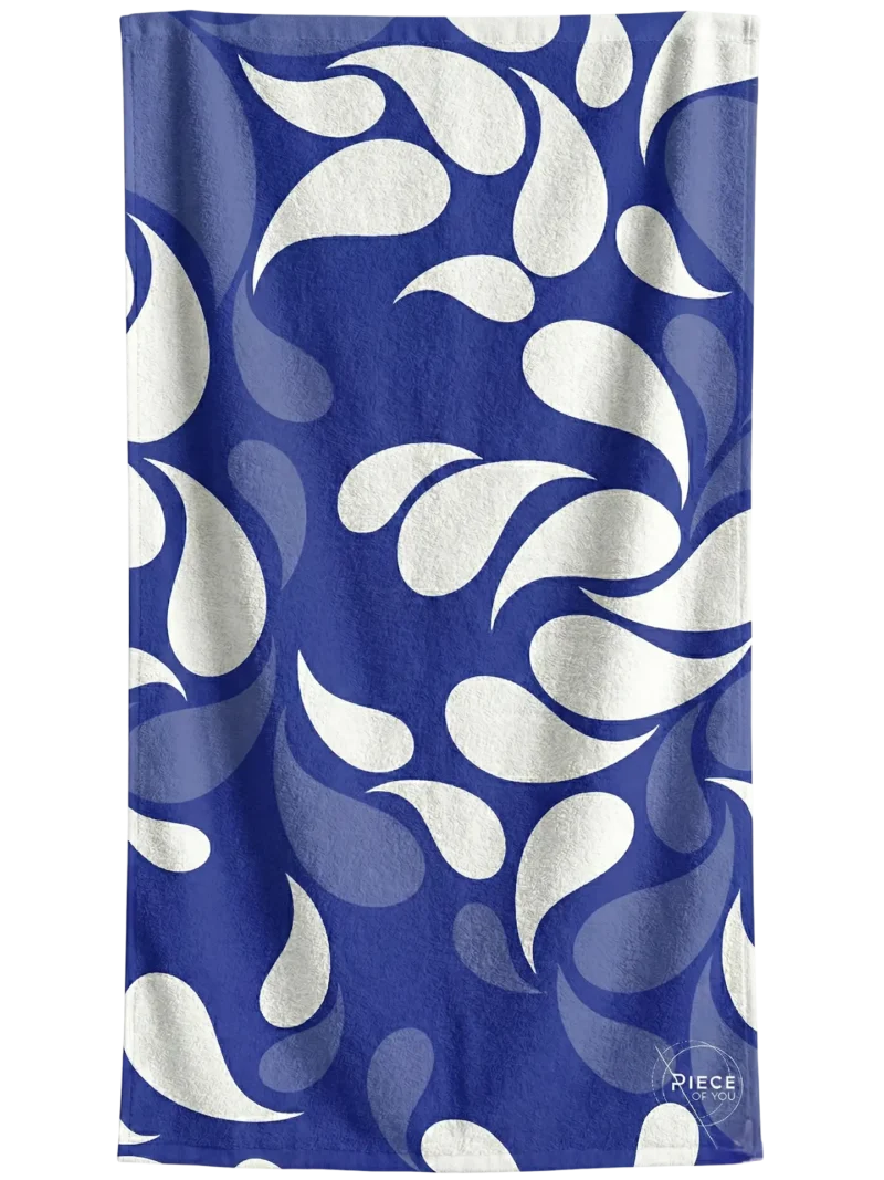 Stagones towel with a flowing, water-inspired Mediterranean pattern.